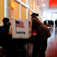 A poll worker talks to a voter before they vote on a paper ballot on Election Day in Atlanta on Tuesday, Nov. 3, 2020. A federal judge, on Thursday, Dec. 9 2021, has rejected motions to dismiss eight lawsuits that challenge Georgia’s sweeping new election law.